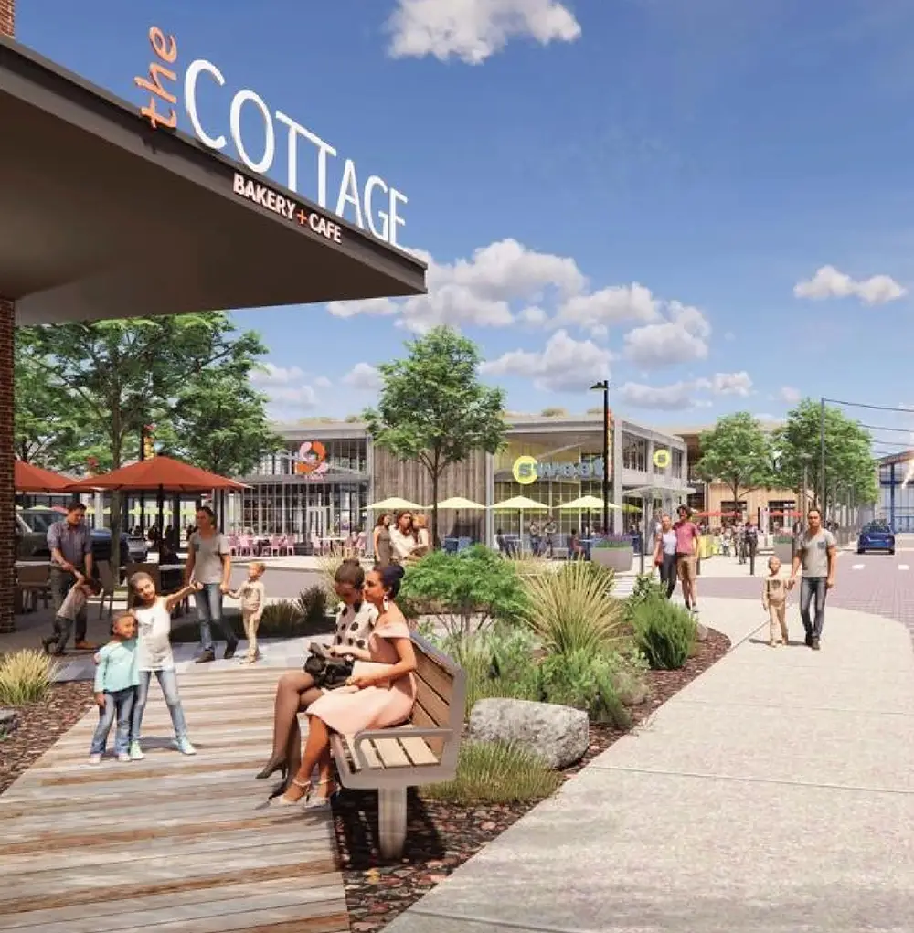 rendering of town center - people sitting at bench, walking on path next to a restaurant