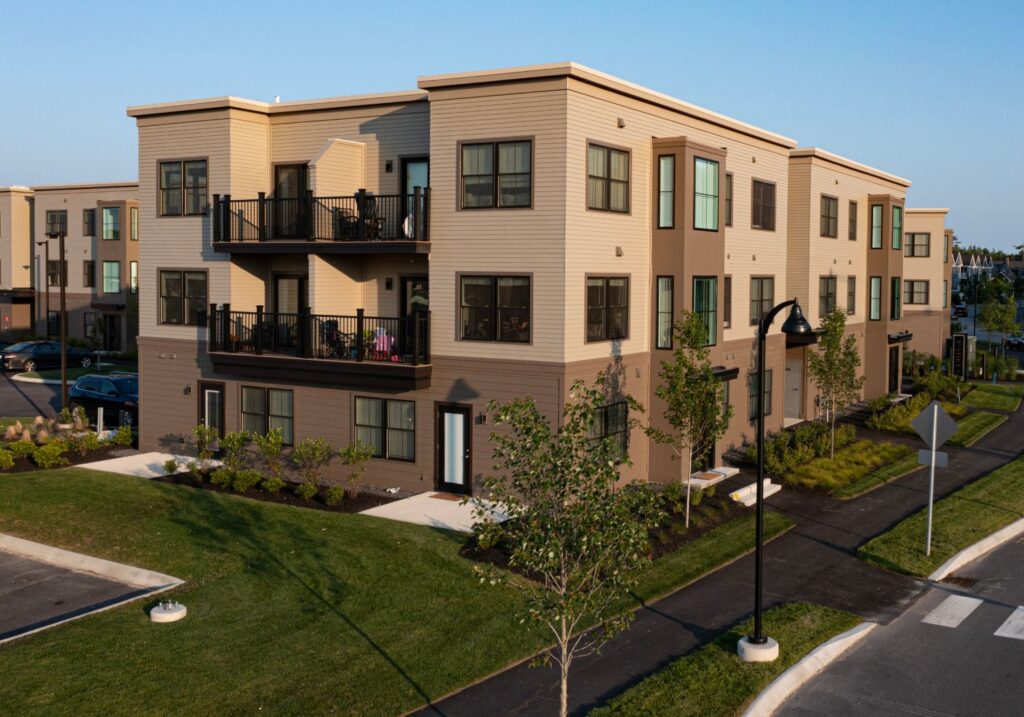 Exterior of The Parker Apartments at The Downs in Scarborough, featuring a green lawn and blue sky.
